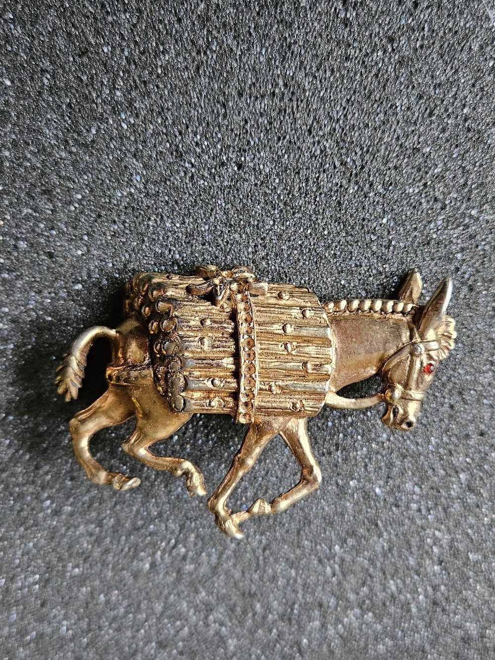 Vintage gold-tone donkey or burro brooch carrying a pack.